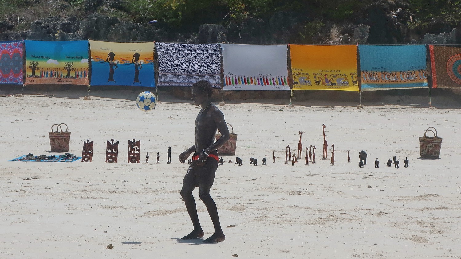 Youngster playing soccer on the beach